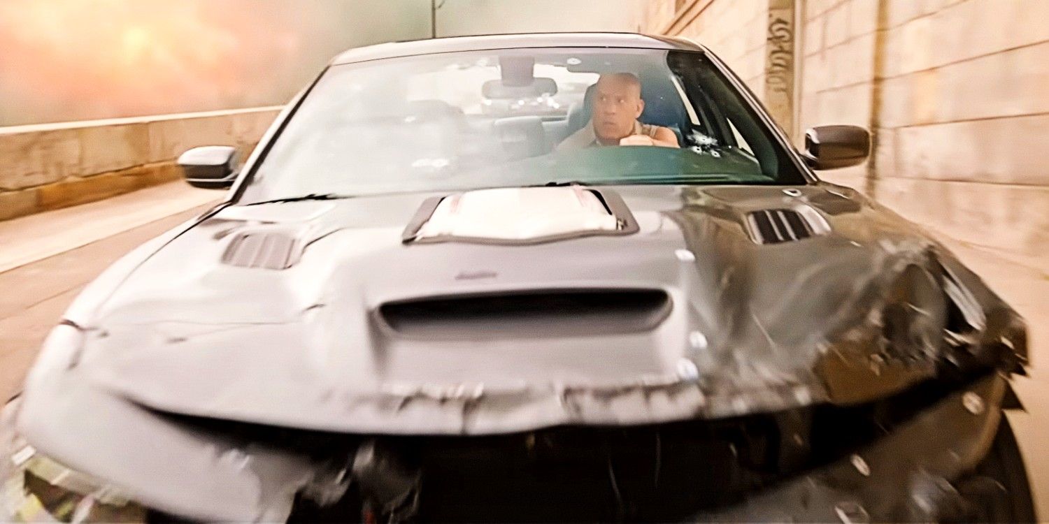 Vin Diesel as Dom Toretto driving a wrecked car in Fast X