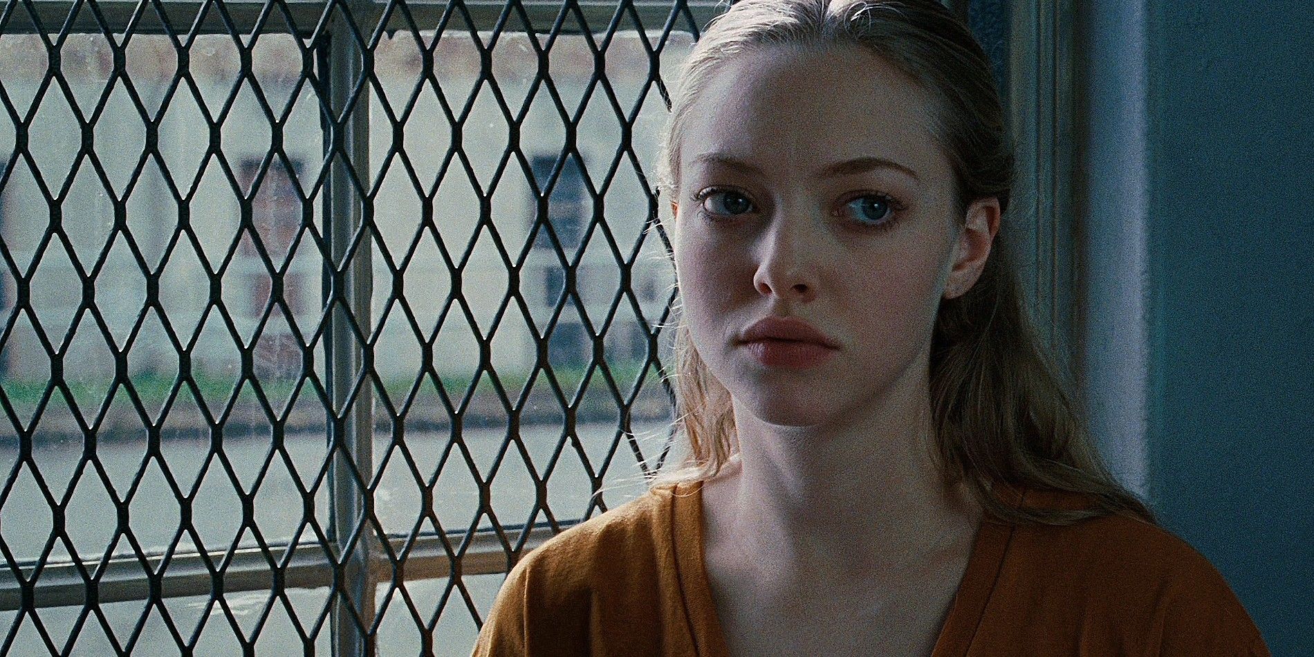 Amanda Seyfried stands by the barred window at the end of Jennifer's body in need