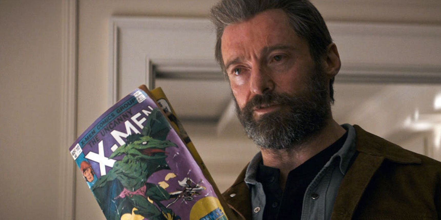 Wolverine with an X-Men comic in Logan