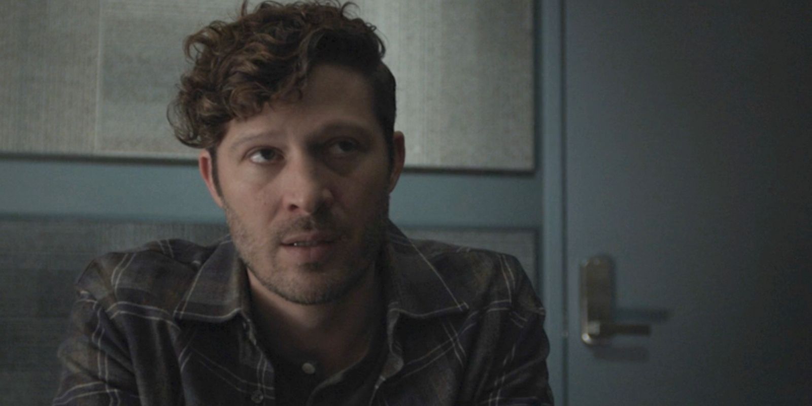 Zach Gilford as Elias Voit looking uneasily off screen in Criminal Minds: Evolution