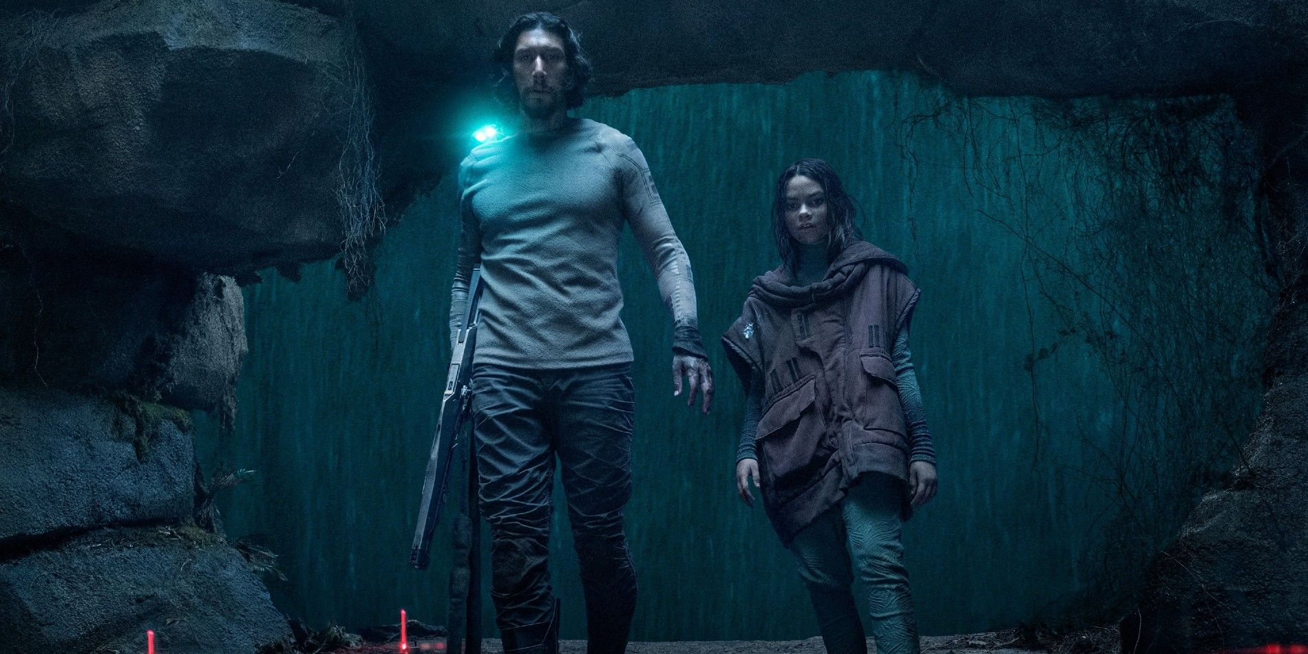 Adam Driver and Ariana Greenblattin walking through a cave in 65