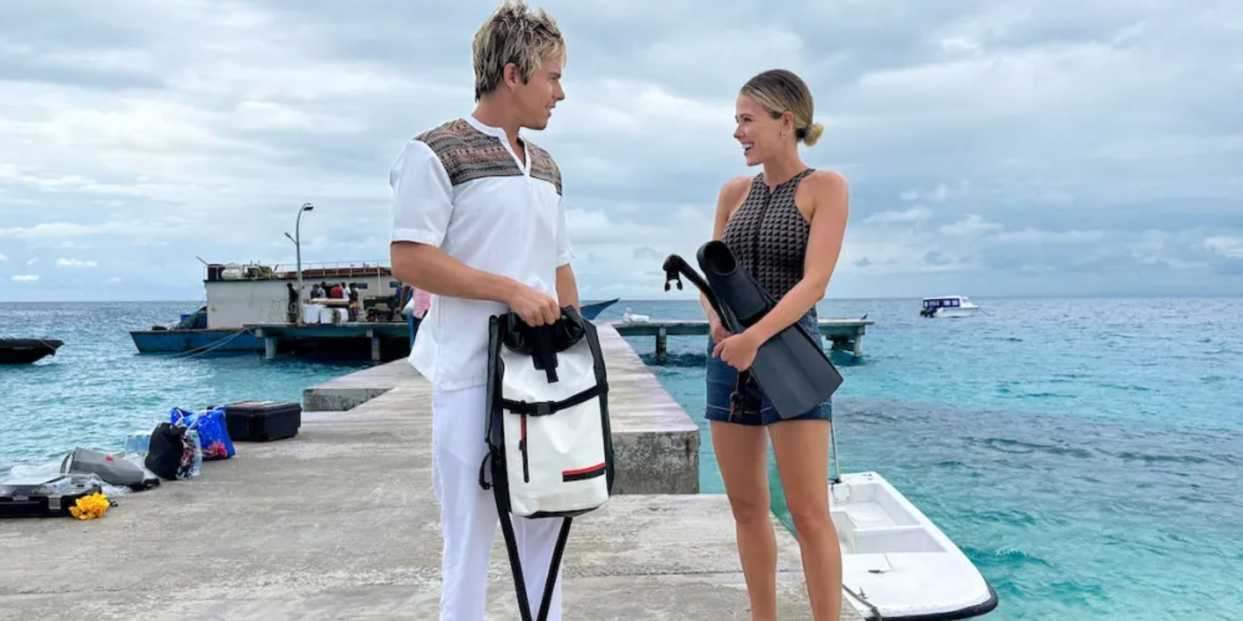 A couple on a pier in Love In The Maldives