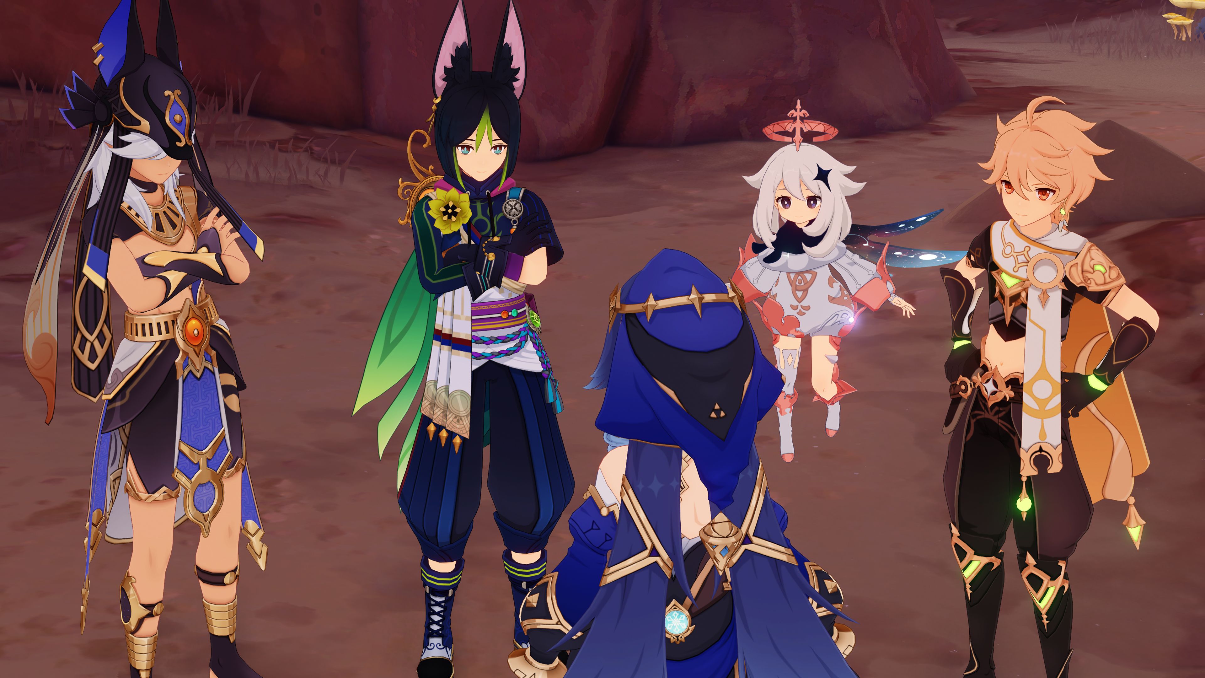 Cyno stands to the left, Tighnari in the middle, and Paimon floats next to the Traveler, on the right. All of them are faced towards the camera, looking at Layla, whose back is featured in the image. They are gathered in a desert area of Sumeru.
