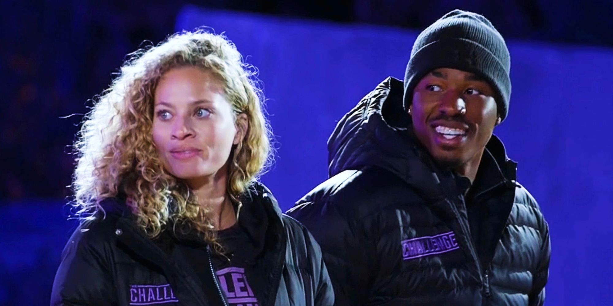 Amber Borzotra and Chauncey Palmer on The Challenge wearing puffy jackets and looking to the side