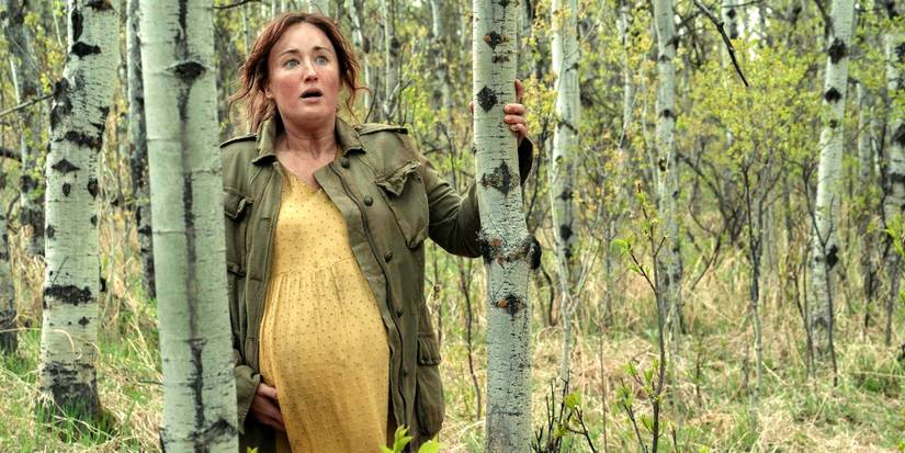 Ashley Johnson as Ellie mother Anna holding a tree for support in The Last of Us season 1 finale