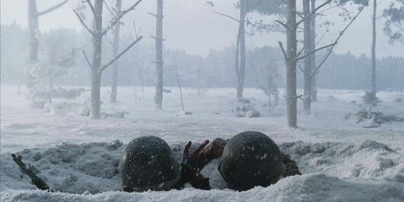 Bastogne Band of Brothers soldiers in wintry trench in Ardennes just helmets visible