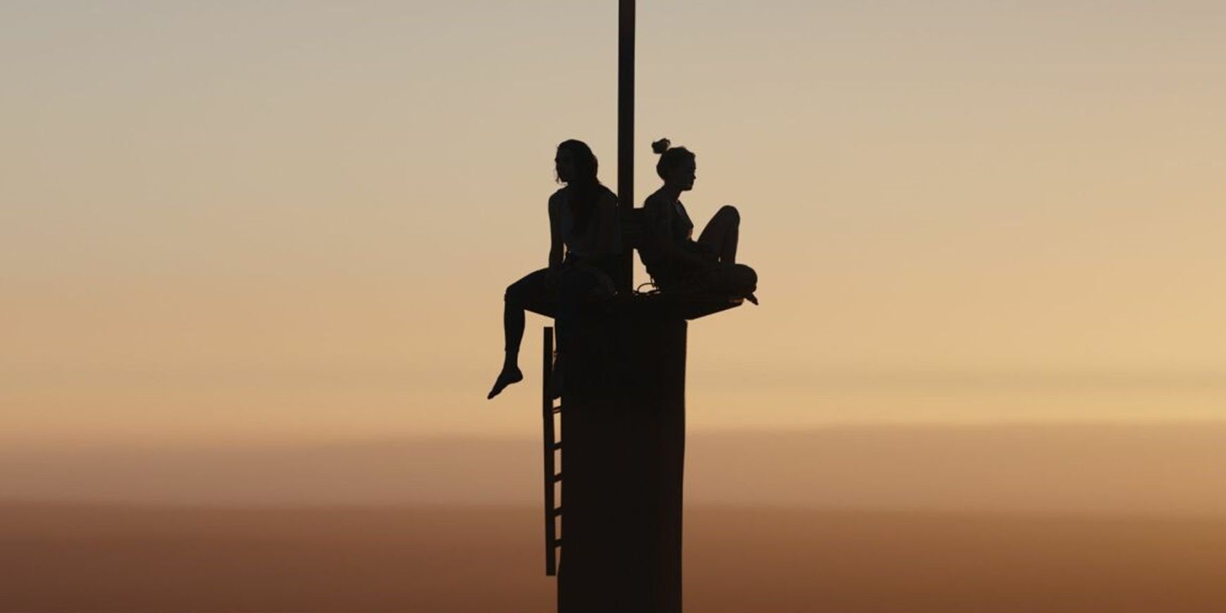 Becky and Hunter sitting on the tower in Fall