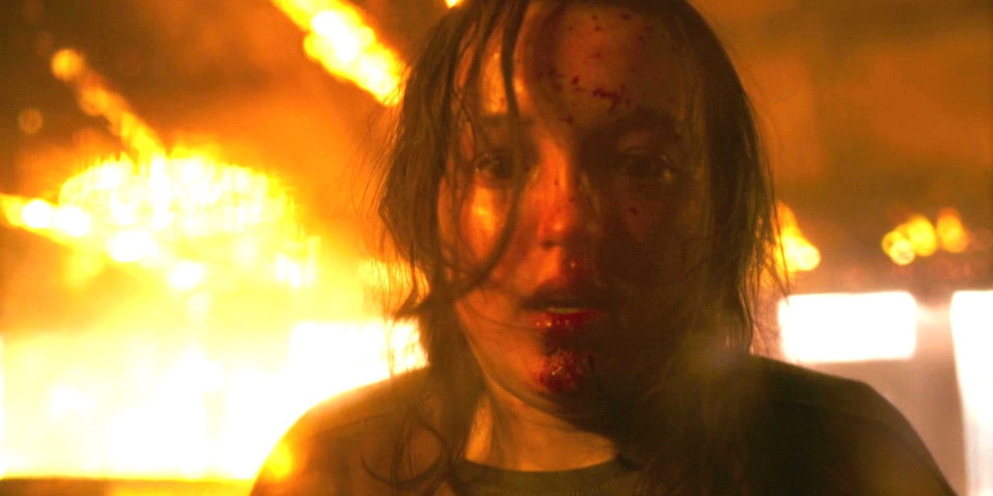 Bella Ramsey in The Last of Us episode 8 looking crazed with blood on her face and fire all around