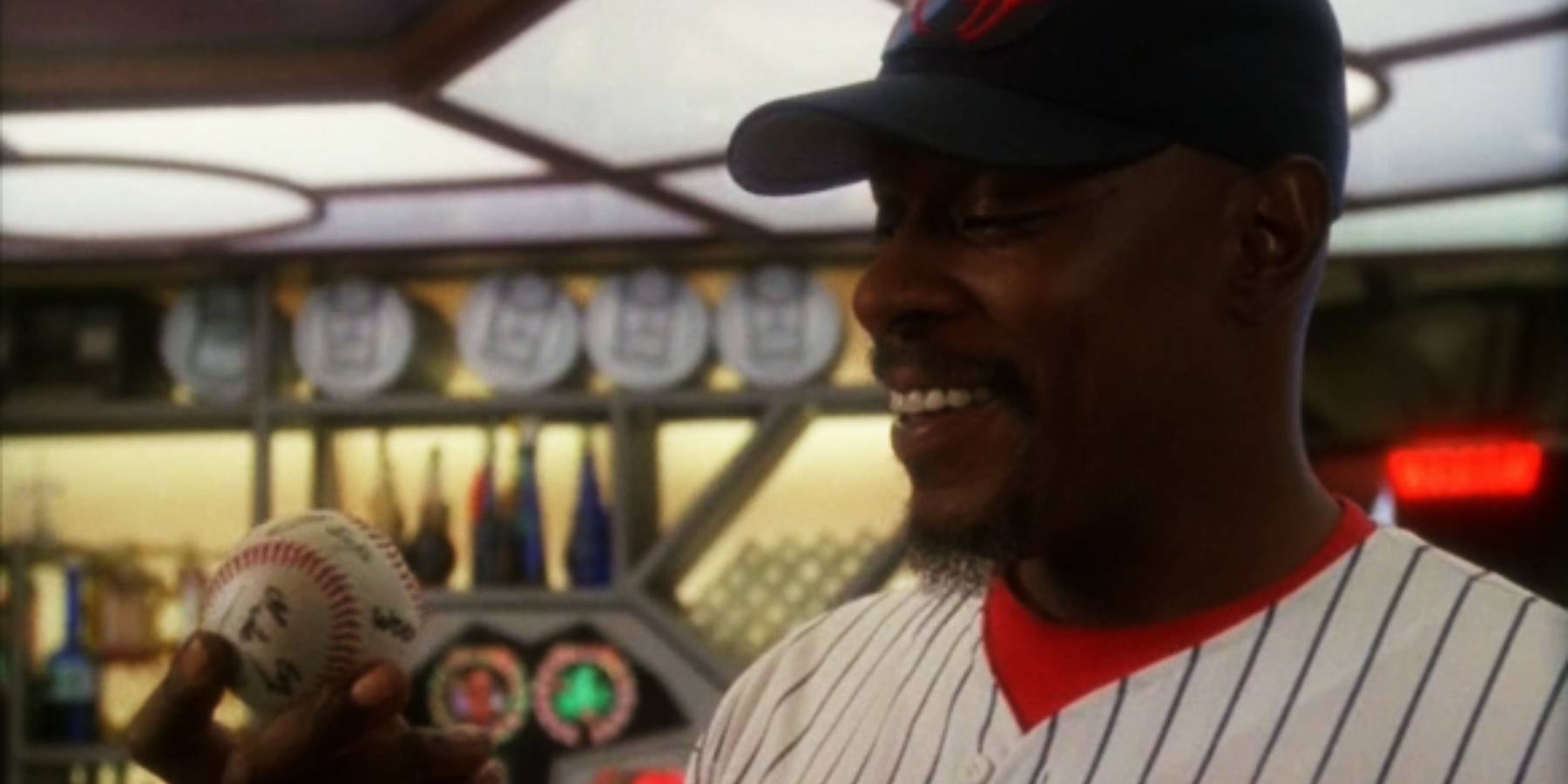 Sisko geared up to play baseball, smiling at the ball