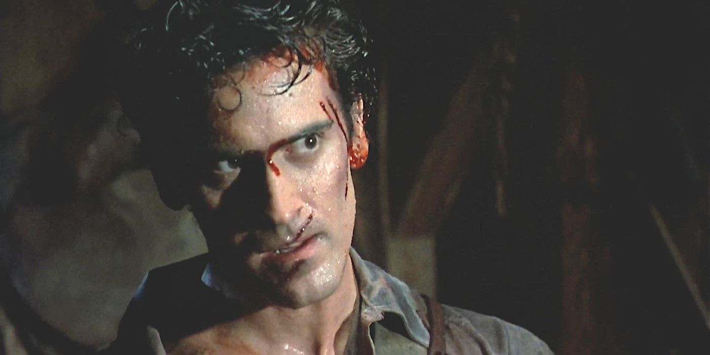Bruce Campbell as Ash in Evil Dead 2 all covered in sweat with his face cut up and bloody
