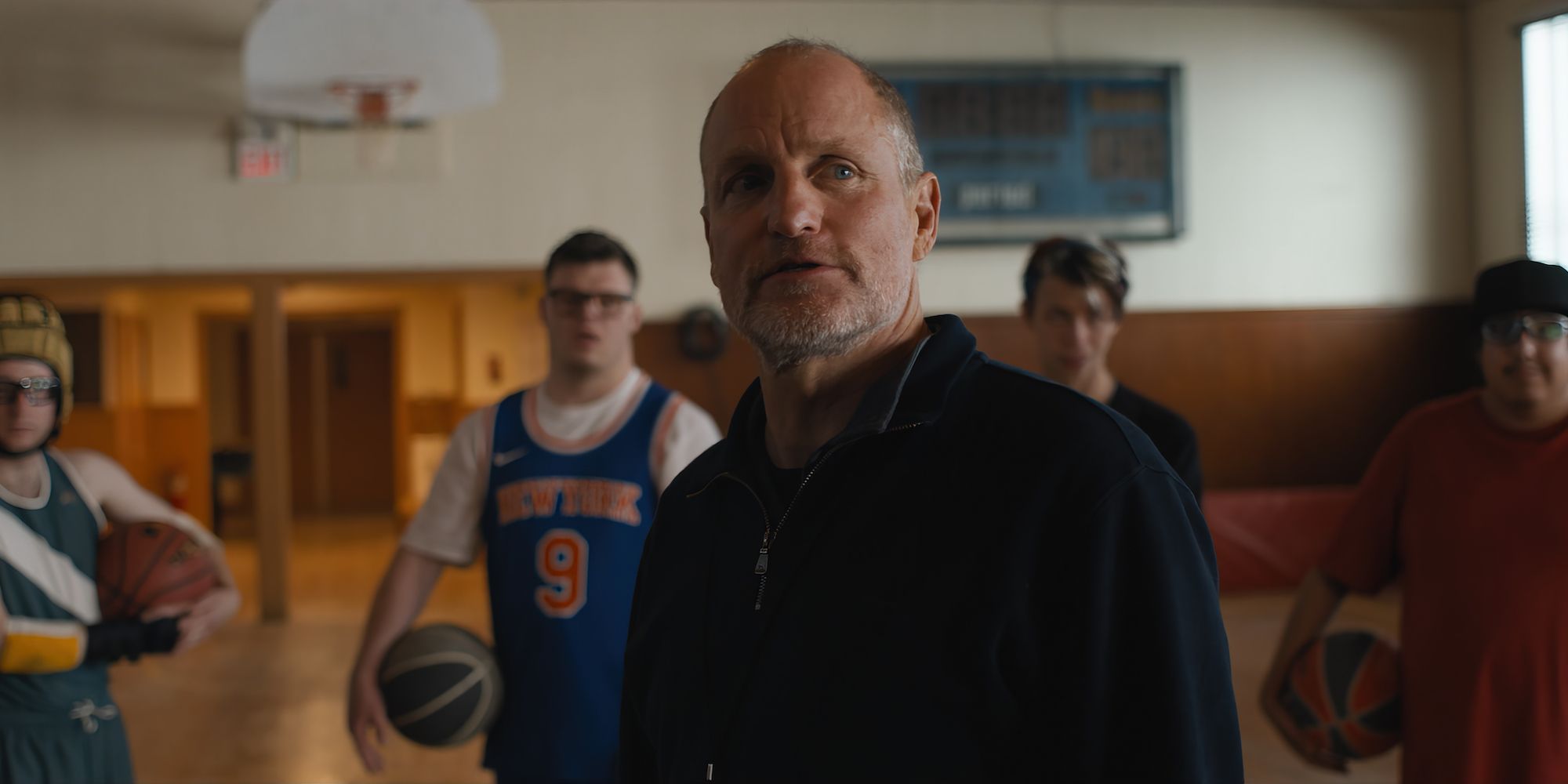 Woody Harrelson as a basketball coach in front of some of his team in Champions