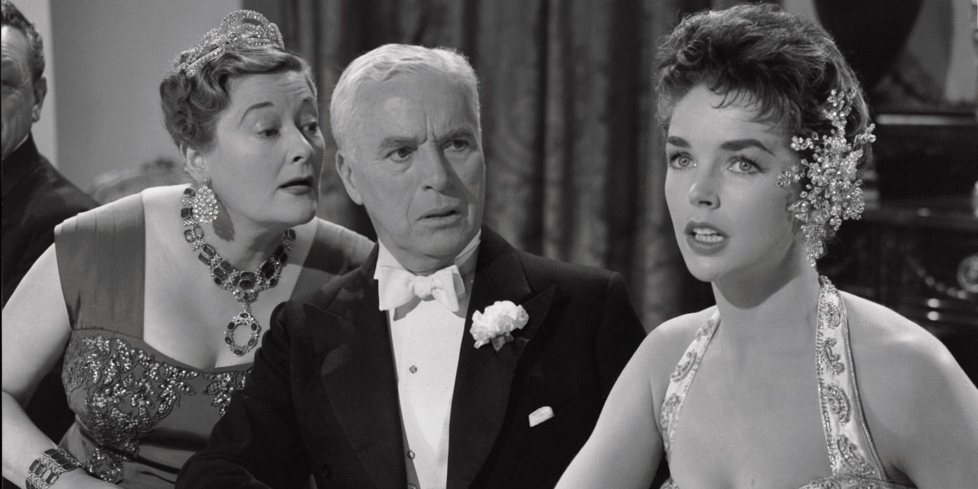 Charlie Chaplin conversa com duas mulheres em A King in New York