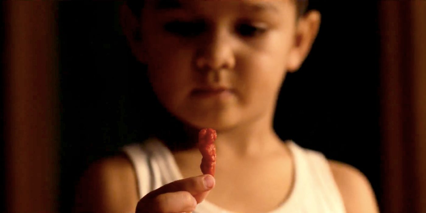 Child Holding a Cheeto in Flamin' Hot