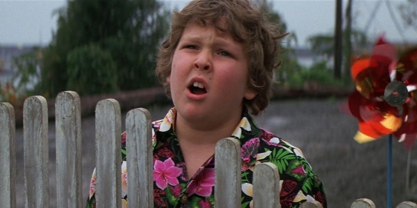 Chunk standing by a fence in The Goonies