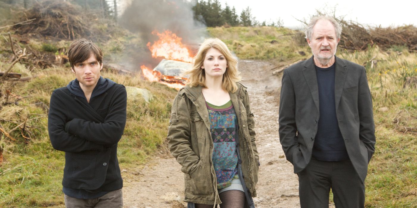 Cillian Murphy, Jodie Whittaker, and Jim Broadbent walking from a burning car in Perriers Bounty.