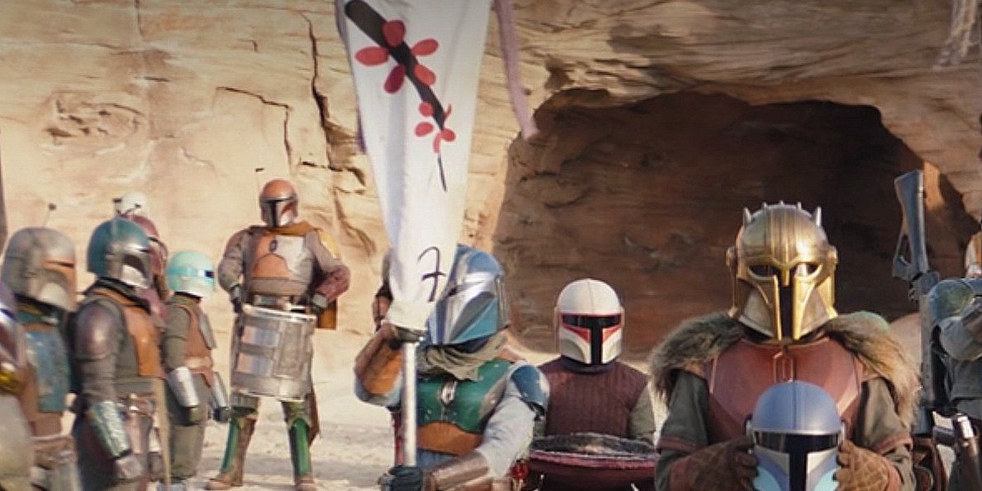 A Mandalorian holding the banner of Clan Vizsla in Mandalorian Season 3