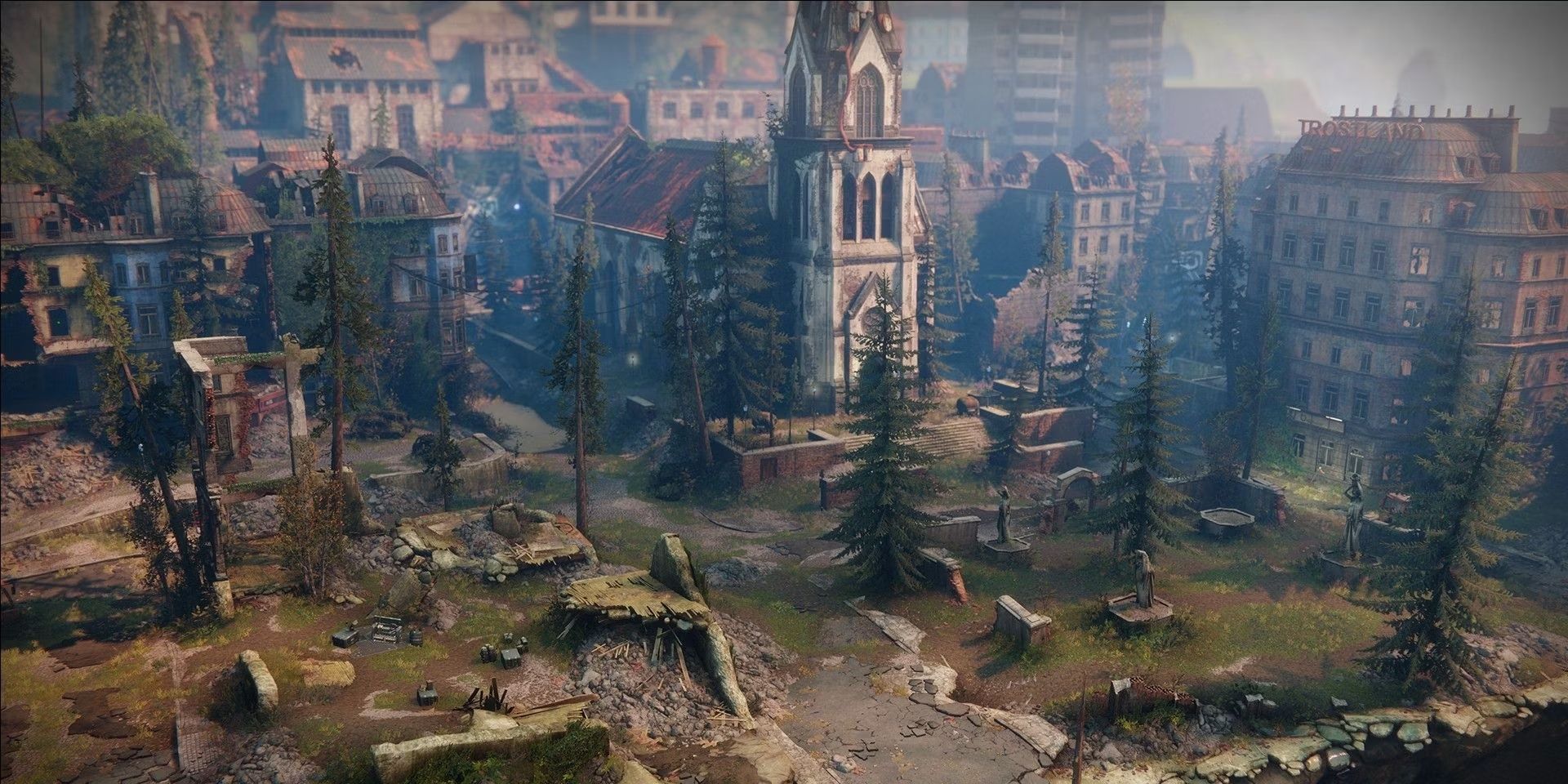 An aerial shot of Destiny 2's Trostland Area in the EDZ, showing the main church in the middle surrounded by ruins of buildings and overgrowing vegetation around it.