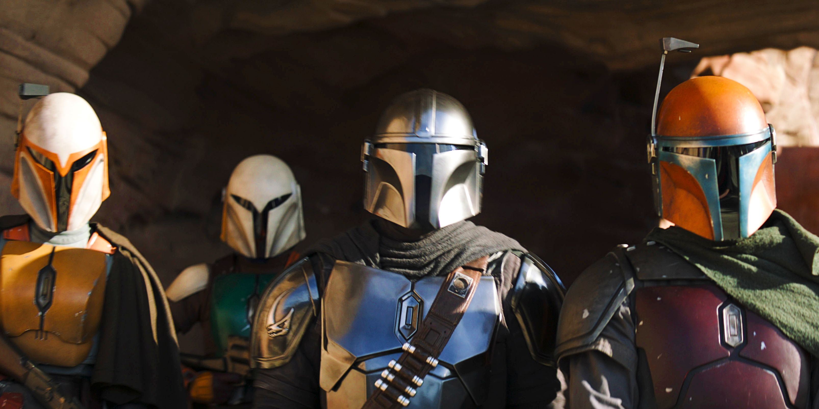 Din Djarin standing with three other Mandalorians