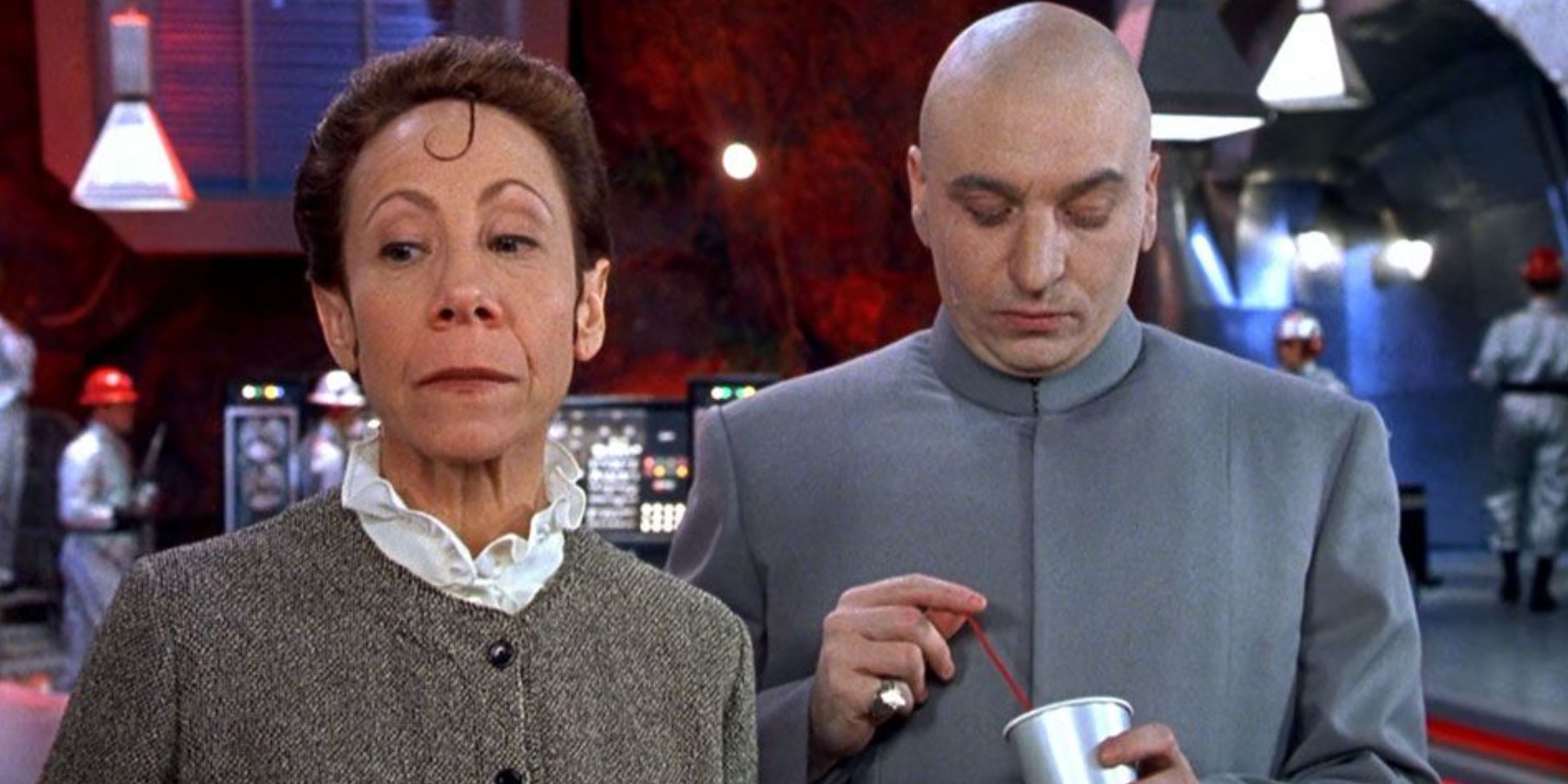 Dr. Evil with his trusted lieutenant Frau, he looking down she looking away in a scene from Austin Powers
