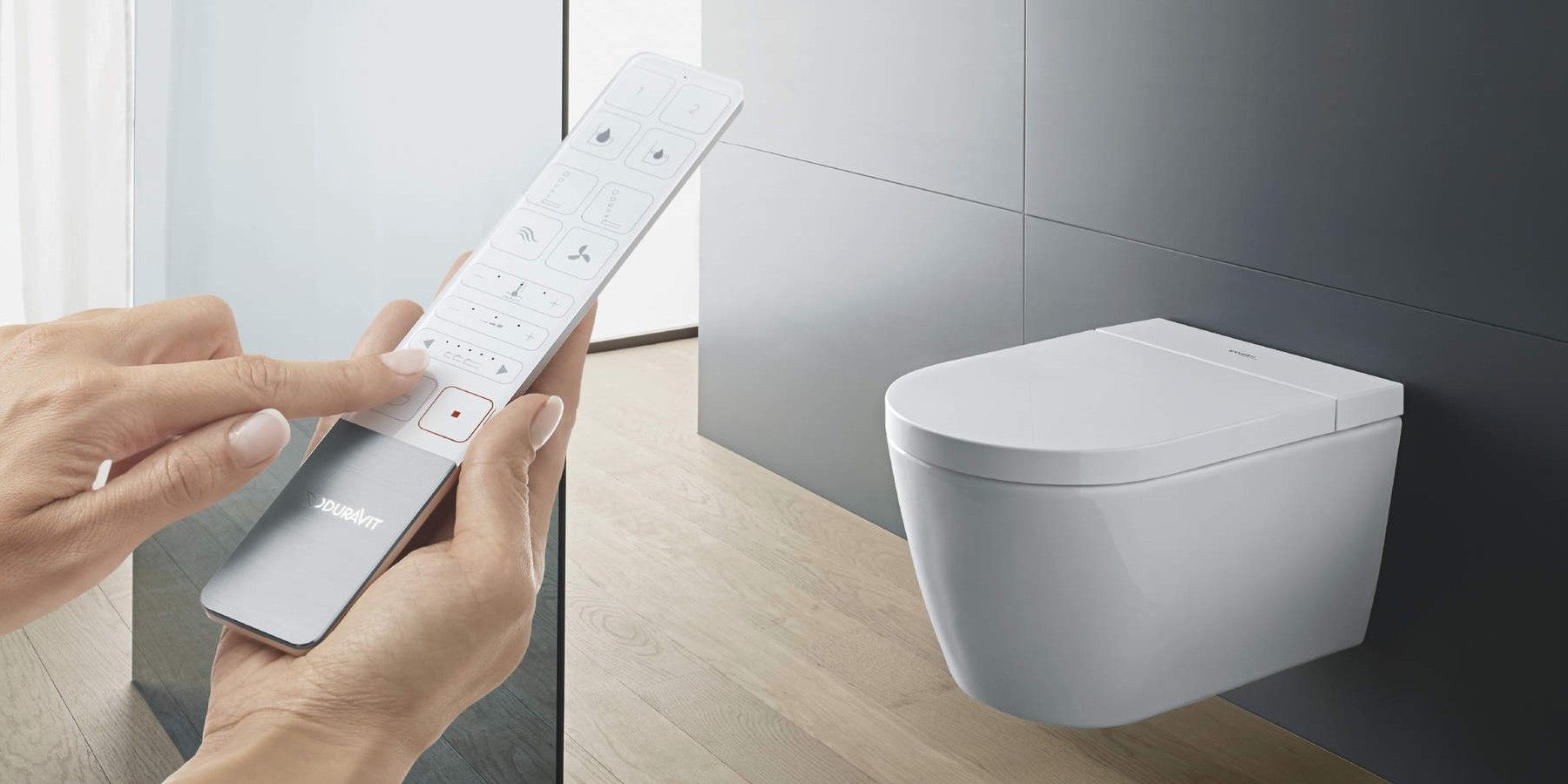 A photo showing a hand holding the remote for the Duravit Sensowash Starck f Plus