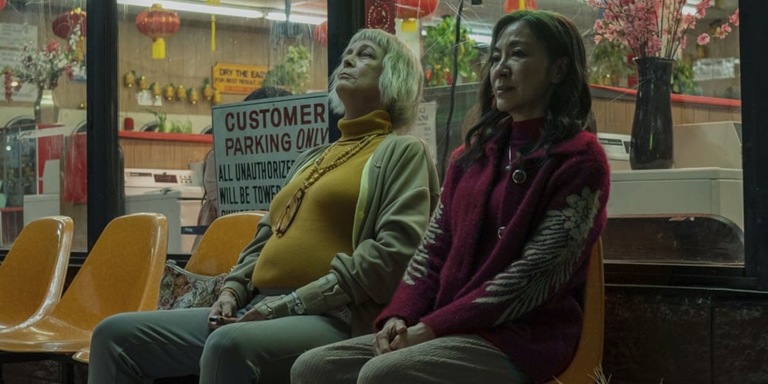 Evelyn and Deirdre sit outside the laundromat in Everything Everywhere All at Once
