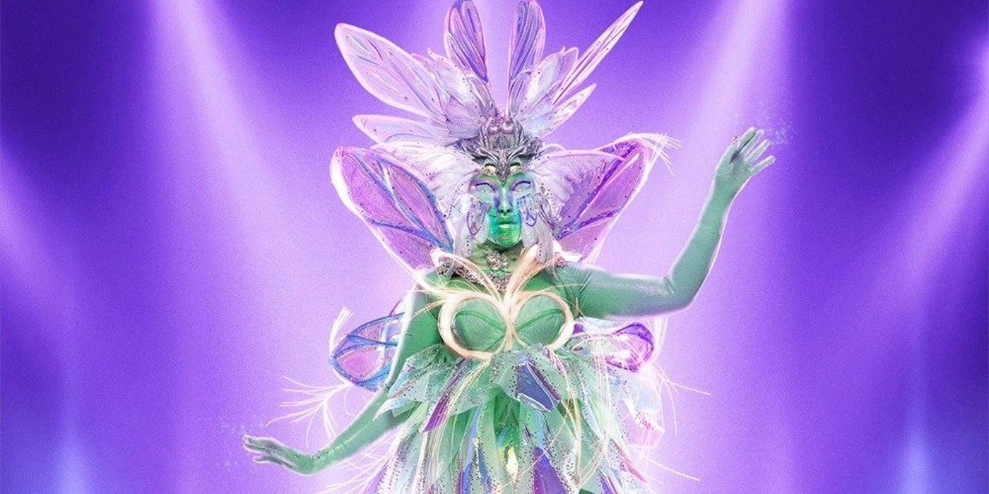 Fairy The Masked Singer fairy posing in front of purple background