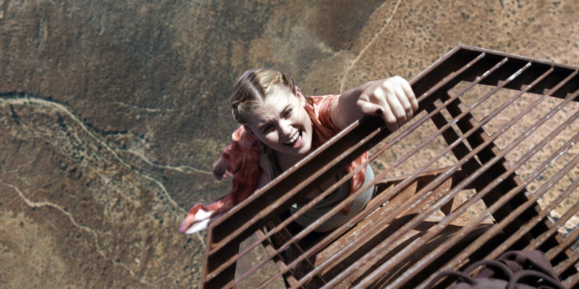 An image of Hunter holding onto a grate in Fall