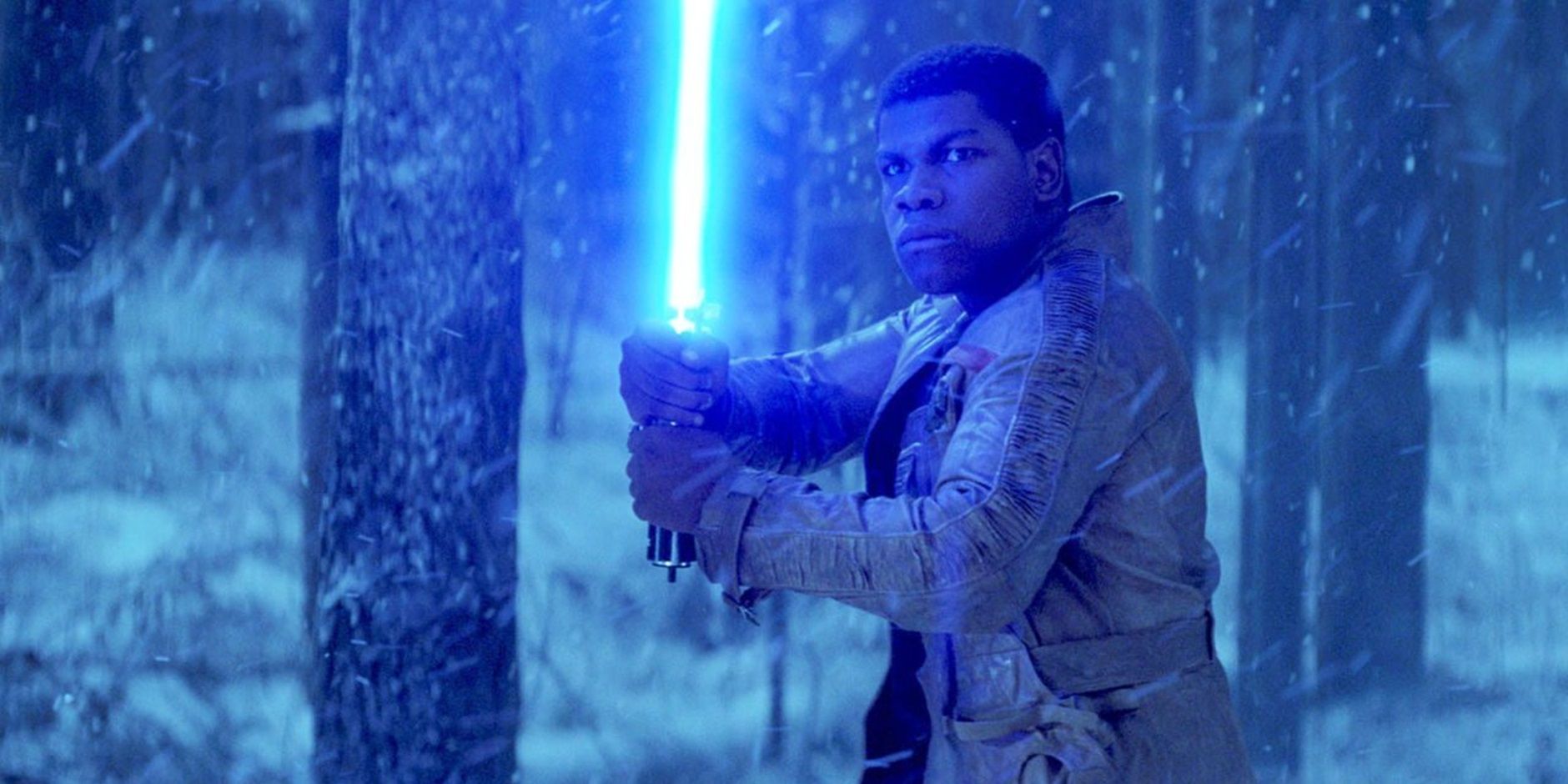 Finn with a lightsaber in The Force Awakens