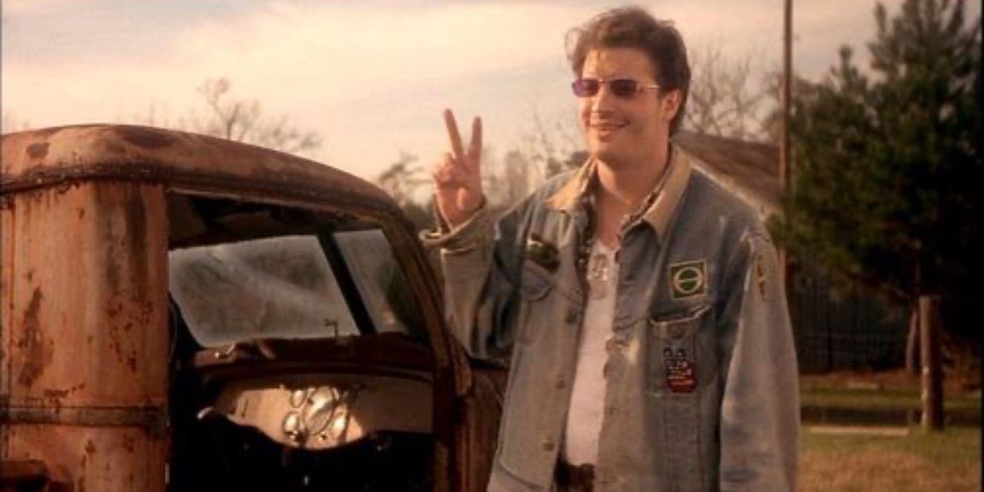 Brendan Fraser gives a peace sign in Now and Then