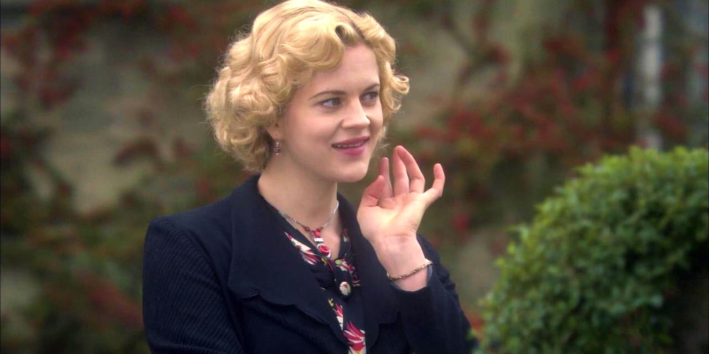 Georgia King raising her hand in Poirot episode Hallowe'en Party