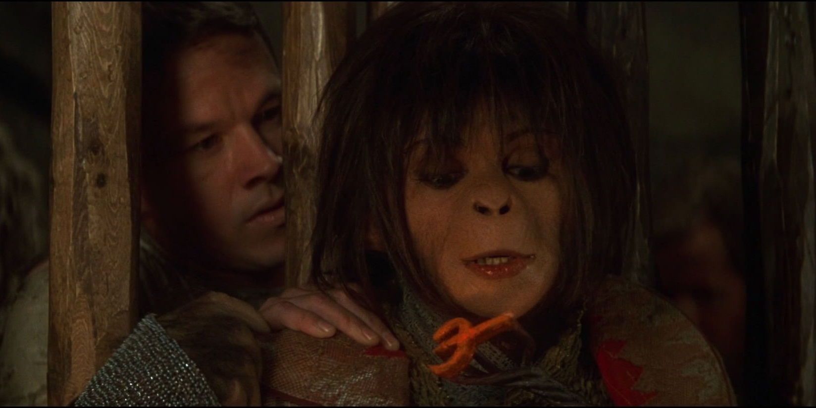 Helena Bonham Carter in ape makeup with a human prisoner in Planet of the Apes