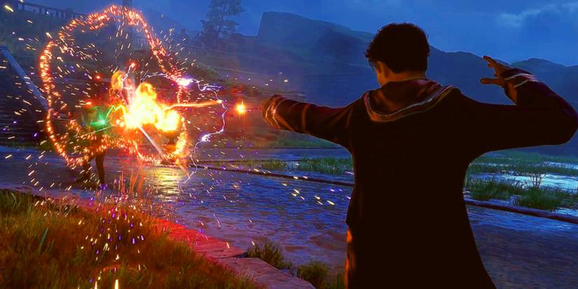 A Hogwarts Legacy student casting an orange spell at an enemy, sending sparks flying.