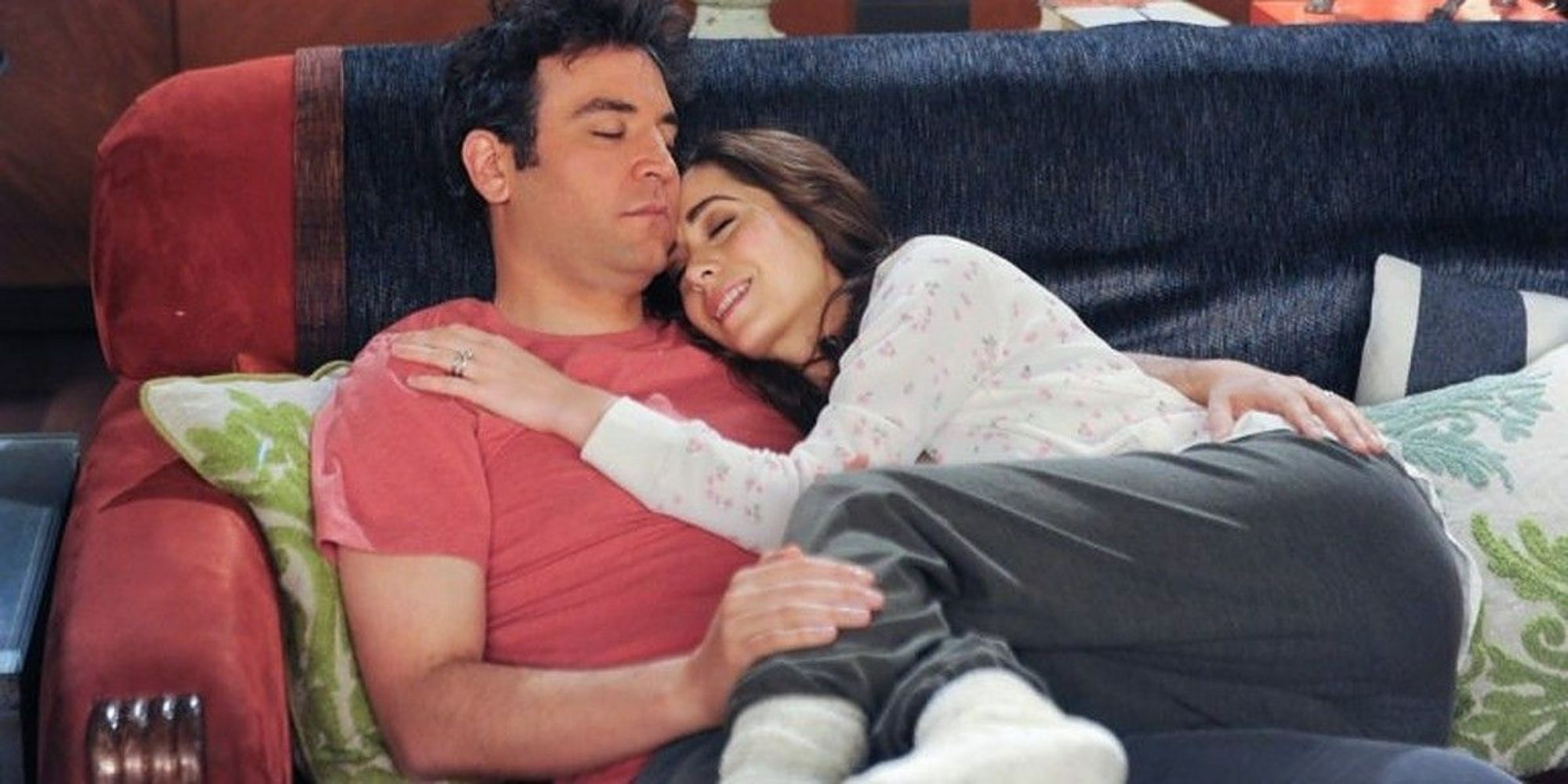 Josh Radnor as Ted and Cristin Milioti as Tracy cuddling on the couch in How I Met Your Mother