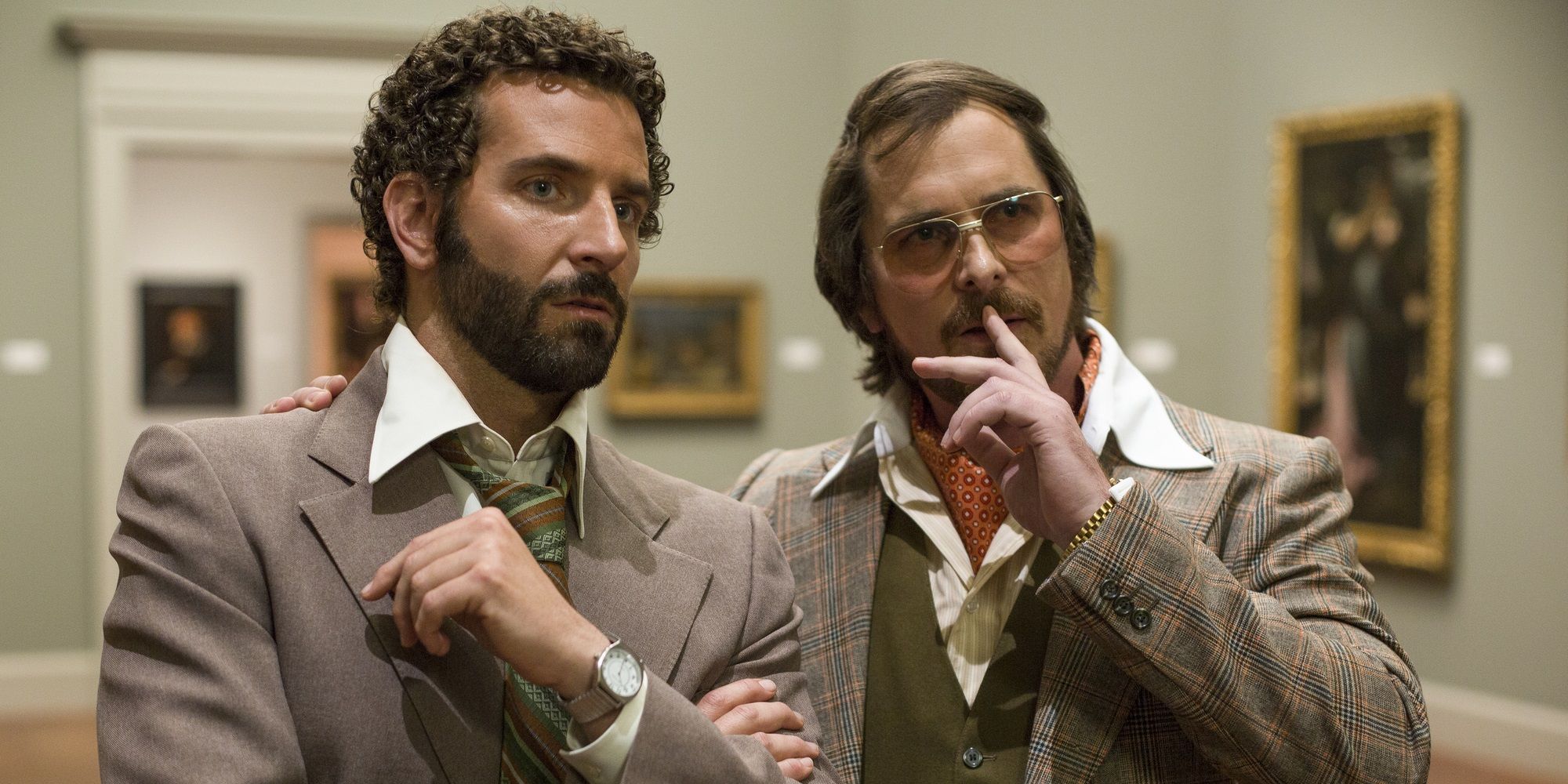 Irving and Richie in a gallery in American Hustle