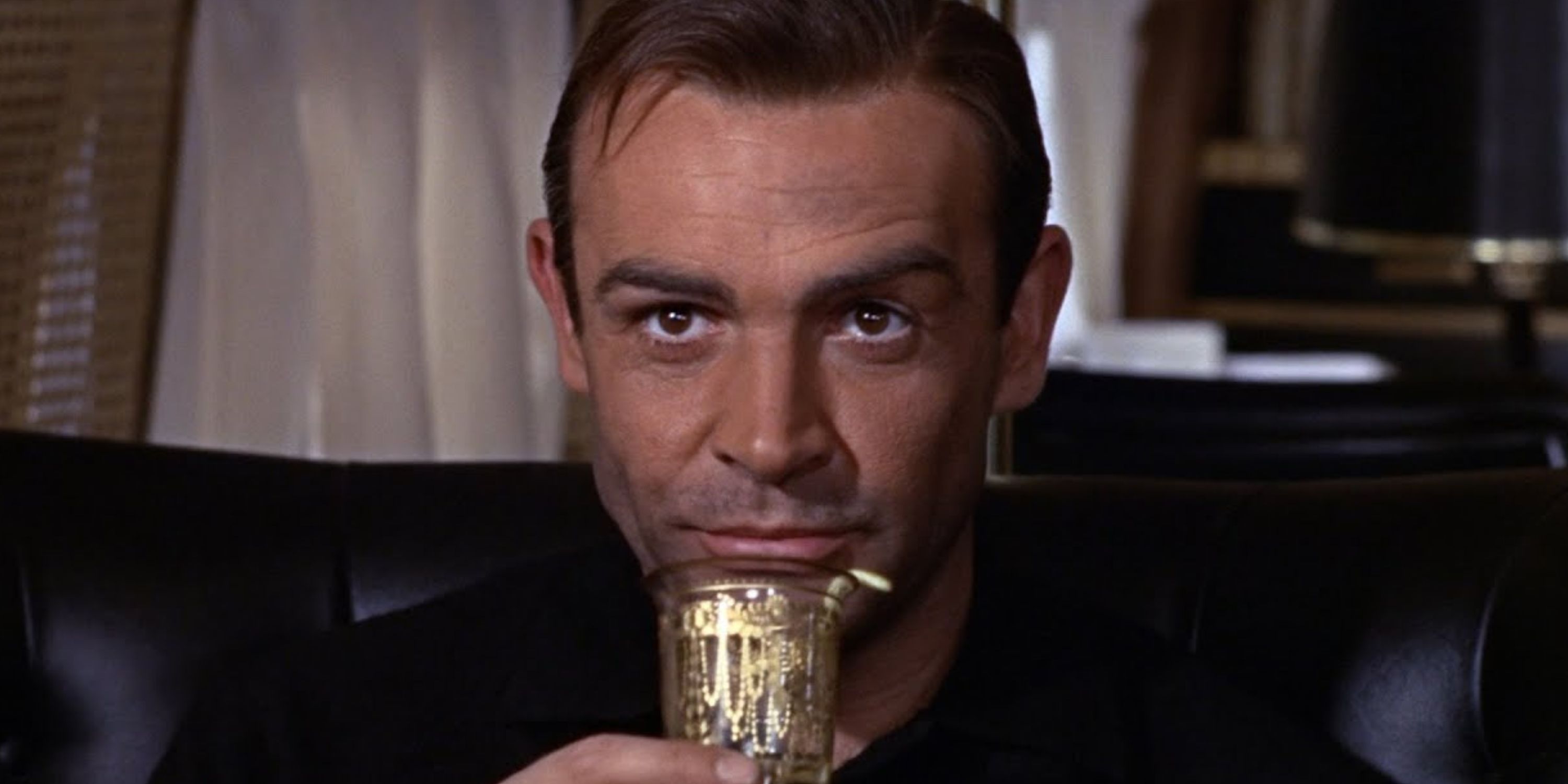 James Bond drinking a martini on Goldfinger's plane
