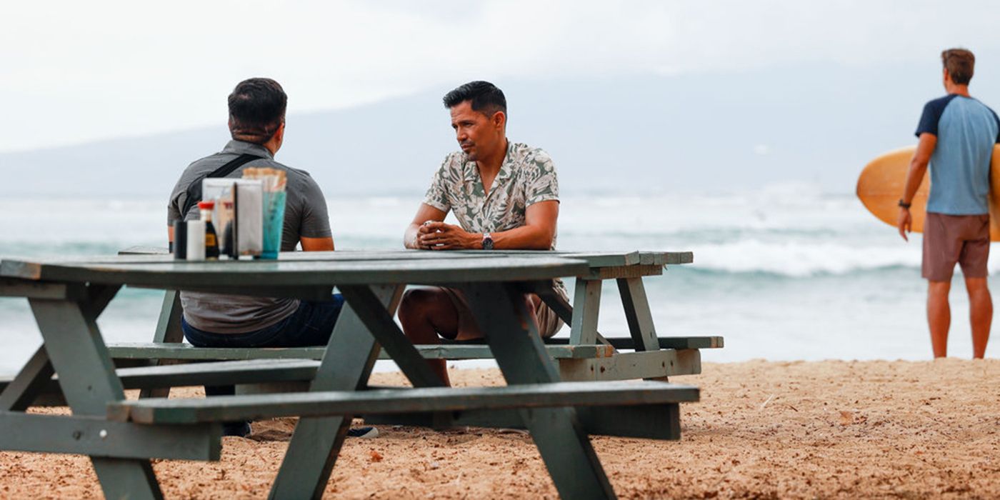 Jay Hernandez in Magnum PI talking to someone at the beach.