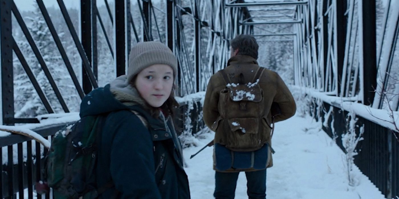 Ellie looking behind as Joel scouts the horizon in the winter section of The Last of Us