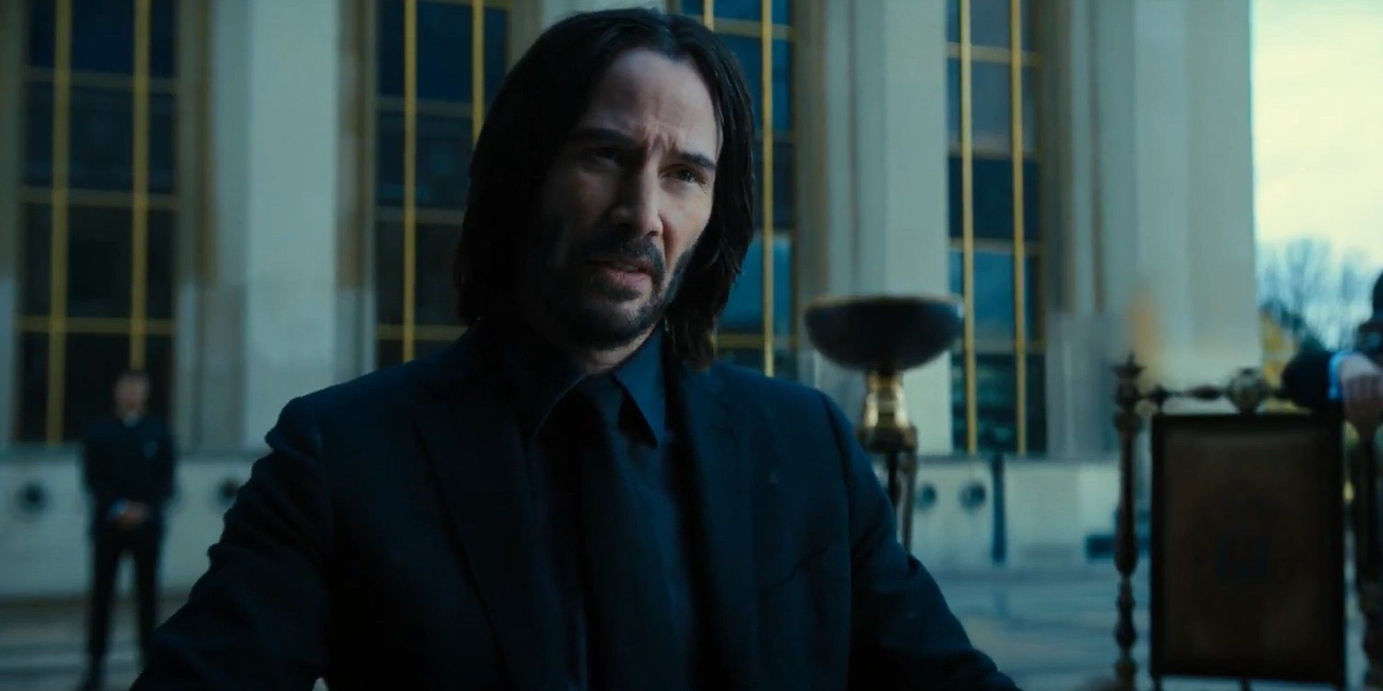 Keanu Reeves as John Wick during a card game in John Wick Chapter 4