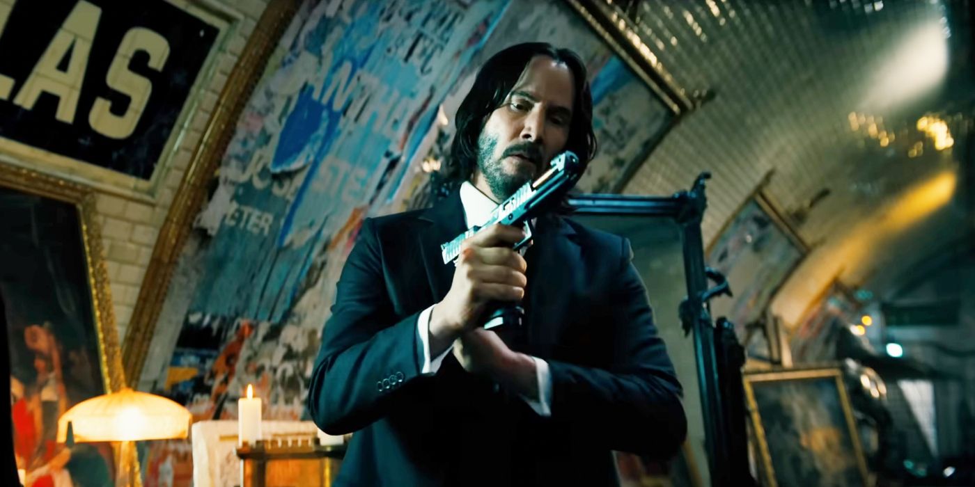 Keanu Reeves as John Wick racking the slide on his pistol in Chapter 4