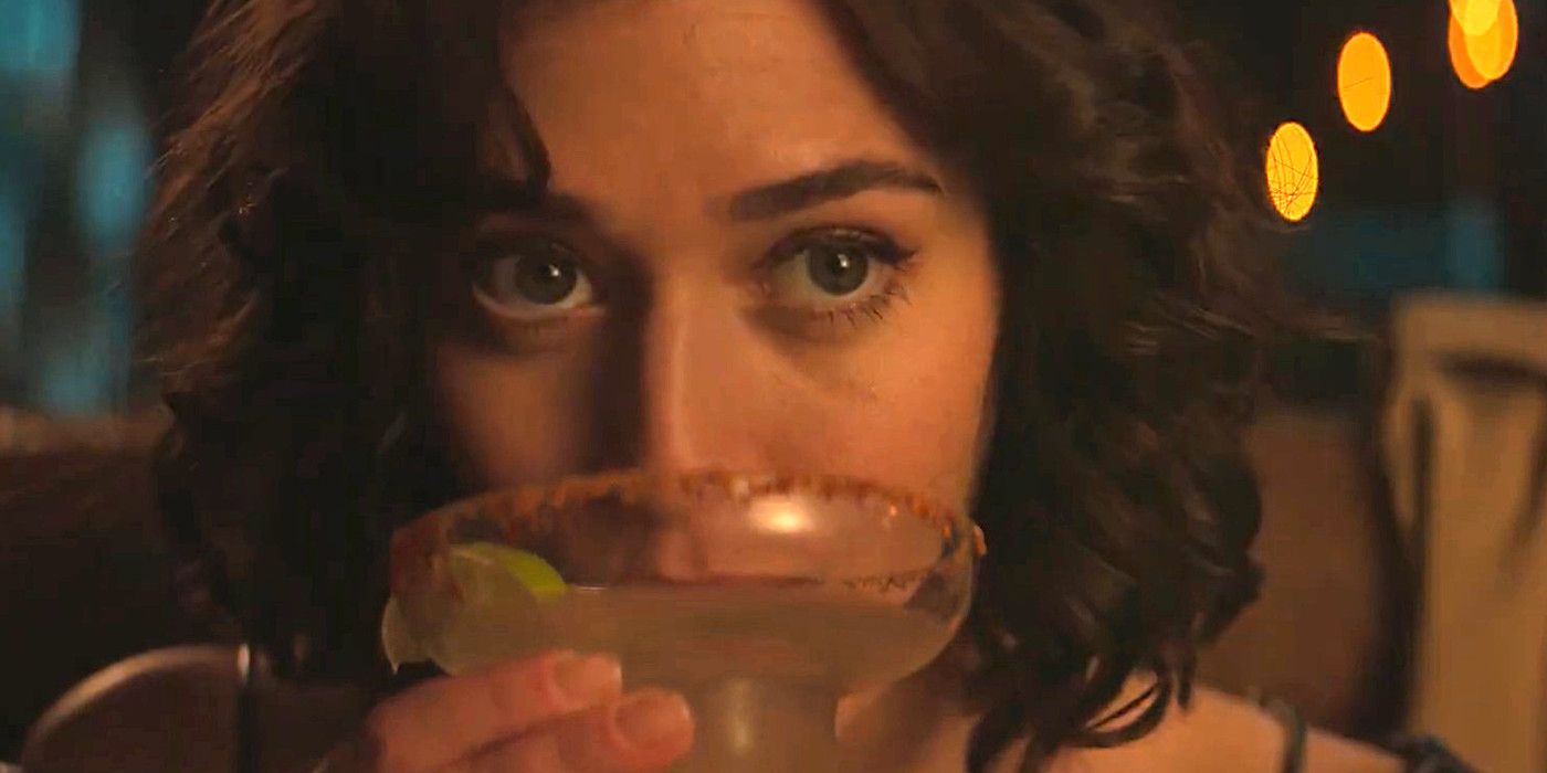 Lizzy Caplan in Fatal Attraction gazing seductively as she sips on a margarita