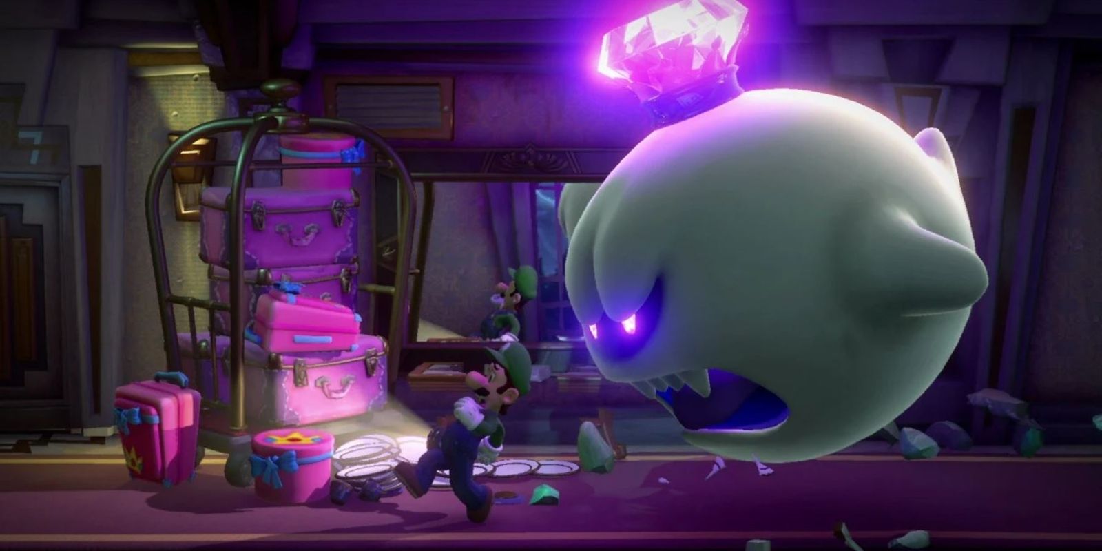 Luigi's Mansion 3 screenshot with Luigi running past some luggage with King Boo chasing him.