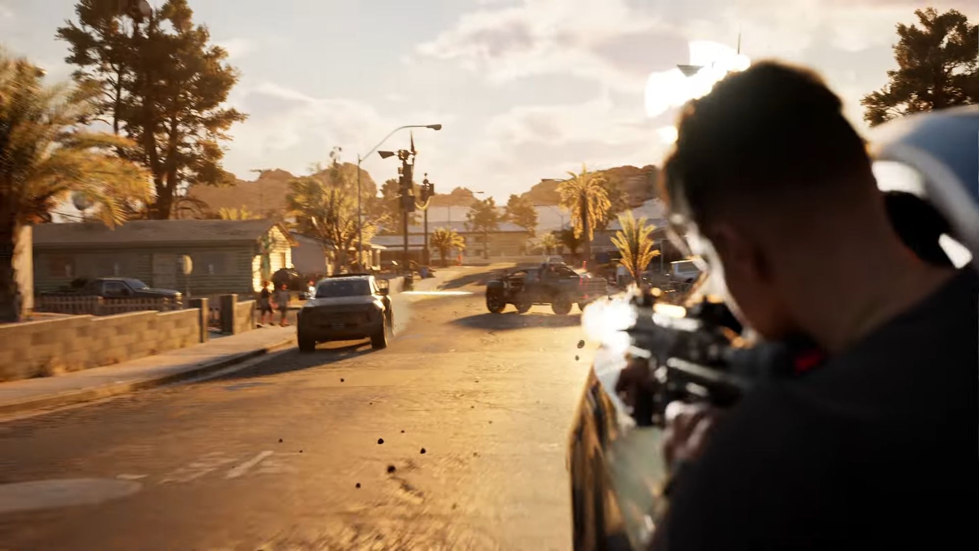 Gameplay screen shot of MindsEye with camera positioned over a young man's shoulder as fires a weapon towards enemy cars a block down a neighboorhood street.