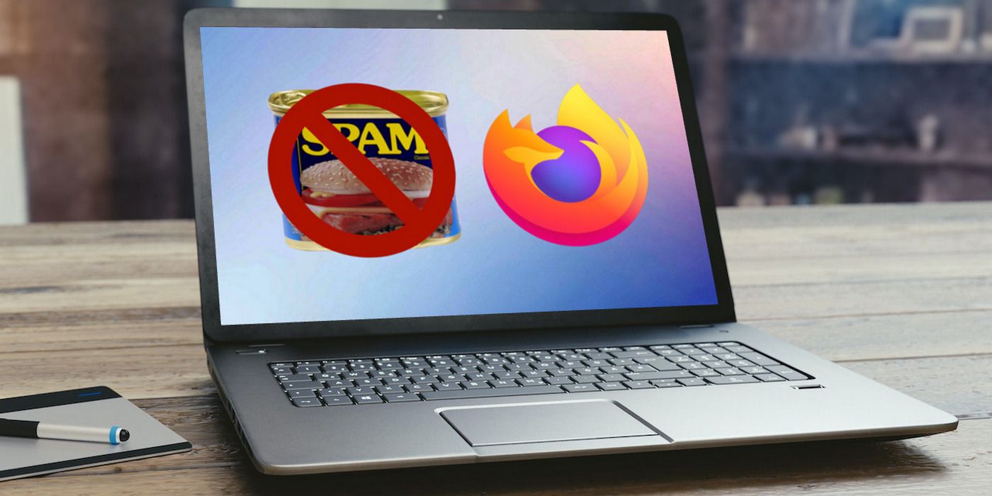 A can of Spam superimposed with the cancel sign, next to the Mozilla Firefox logo displayed on the screen of an open laptop sitting on a wooden desk
