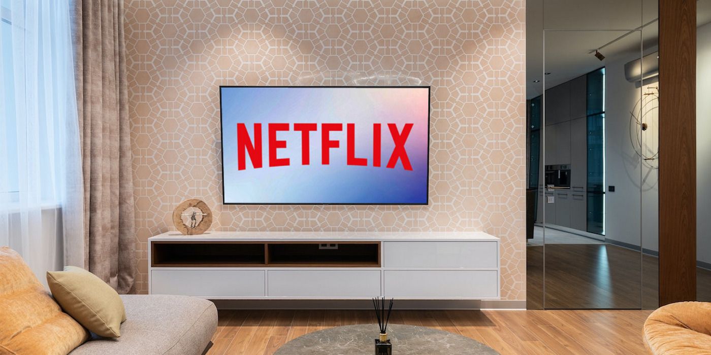 A TV hung on a living room wall, with 'Netflix' written on the screen in red.