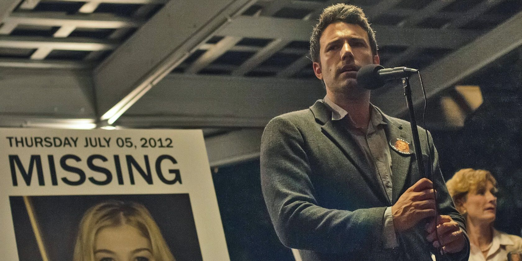 Nick in front of Amy's missing poster in Gone Girl