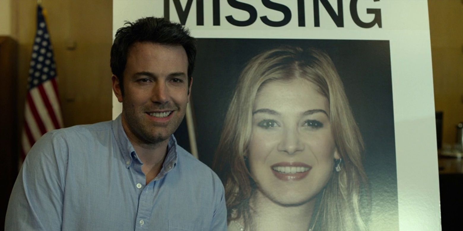 Nick poses with Amy's missing poster in Gone Girl