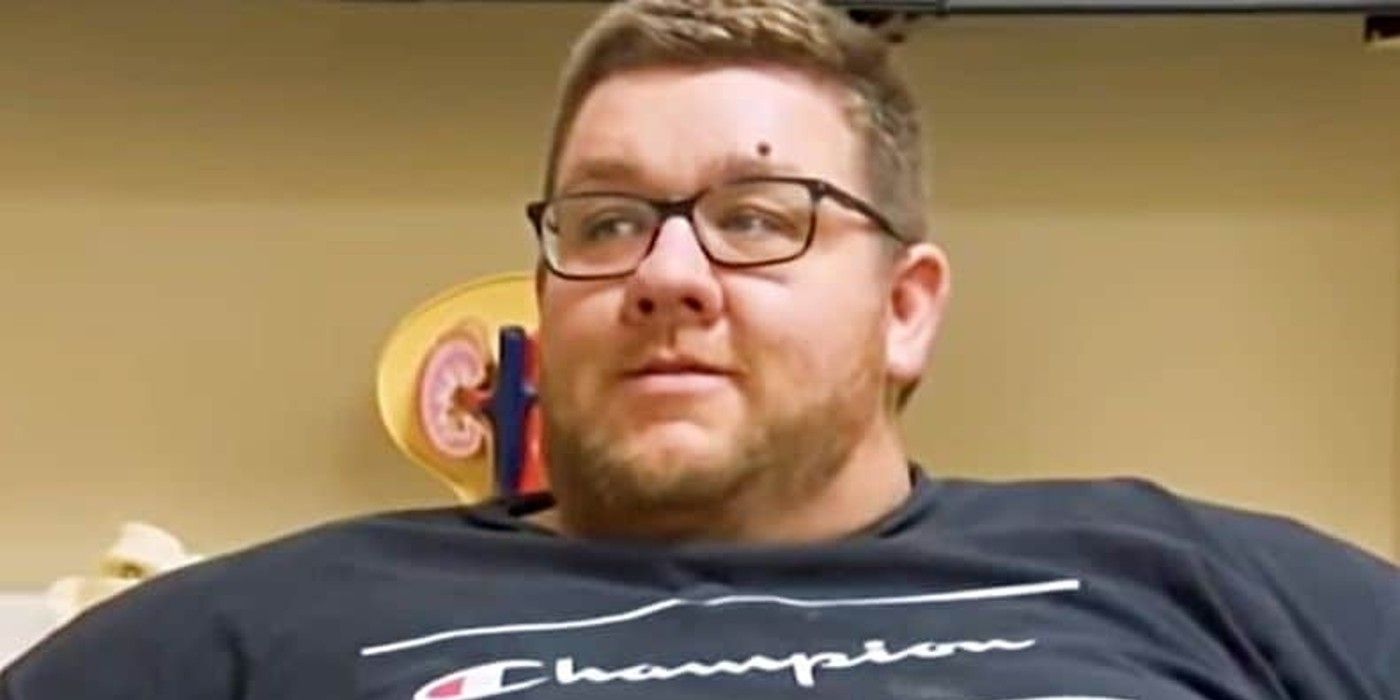 Paul MacNeill My 600-lb Life wearing blacl champion shirt and glasses smiling