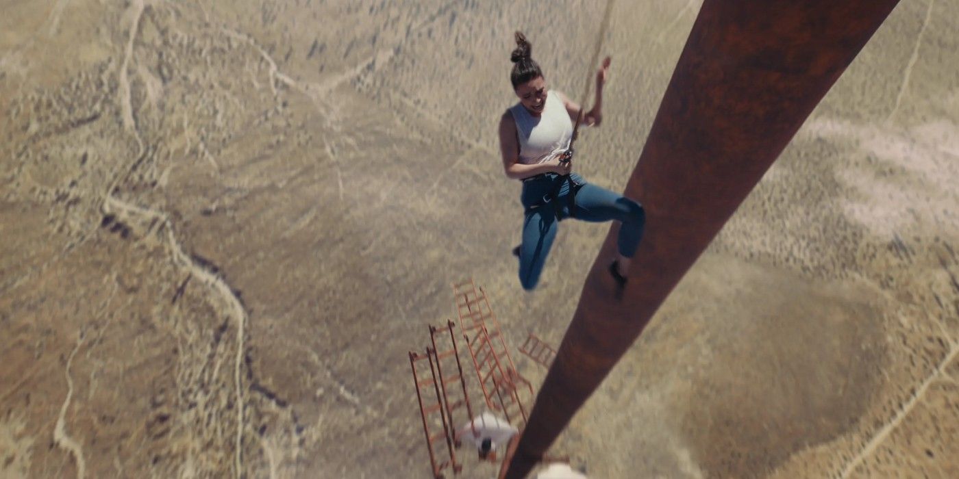 Becky in Fall dangles from tower