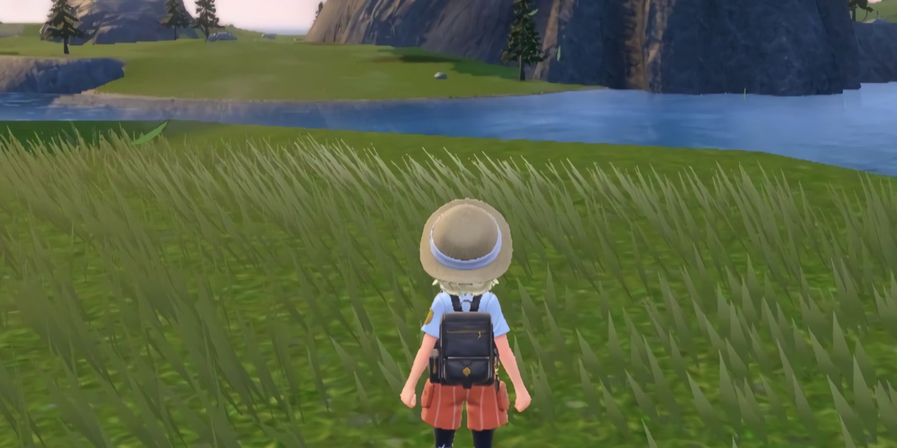 A Pokémon trainer in Pokémon Scarlet and Violet standing next to a river; the area is noticeably devoid of any Pokémon or NPCs.