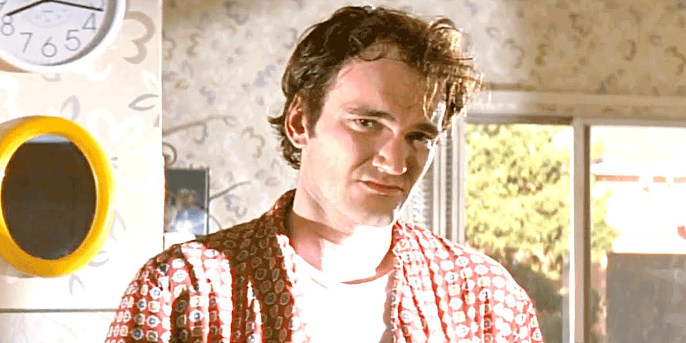 Quentin Tarantino In Pulp Fiction in a kitchen wearing a bathrobe